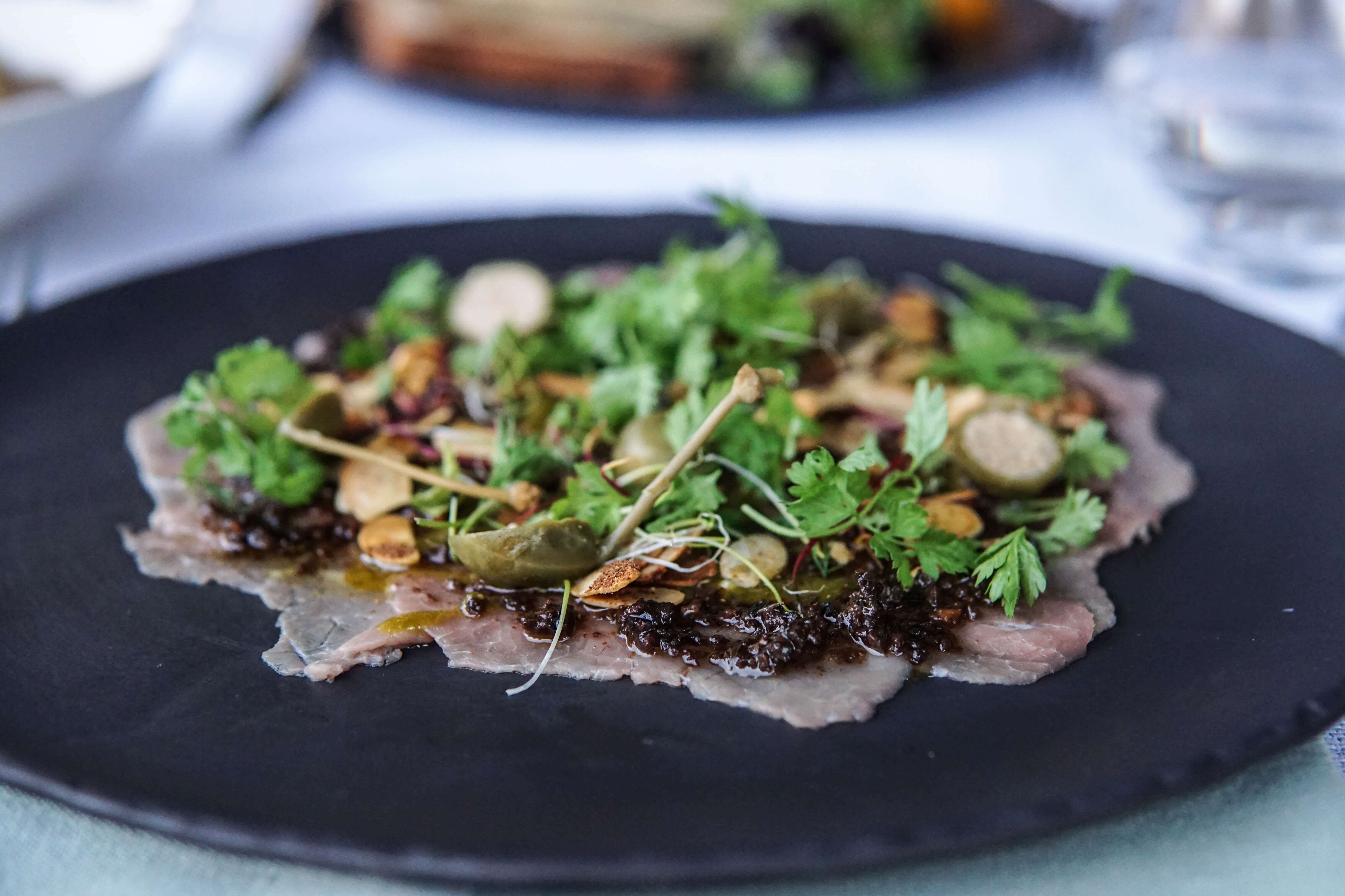 Salmon on a plate served on a table with a glowing ambience
